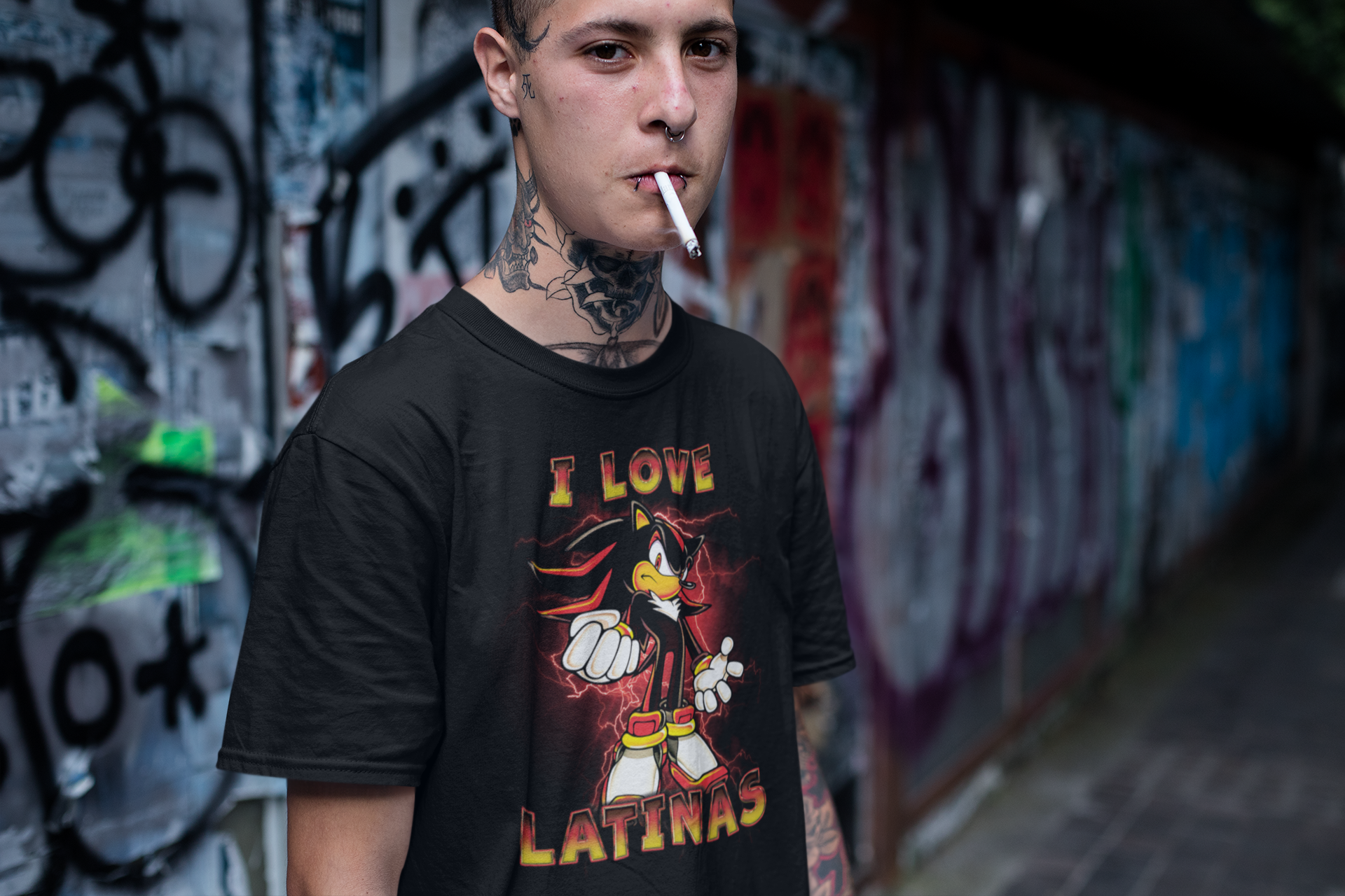 Man with tattos wearing a t-shirt of Shadow the Hedgehog. The words "I Love Latinas" are written across the shirt. The man is smoking.